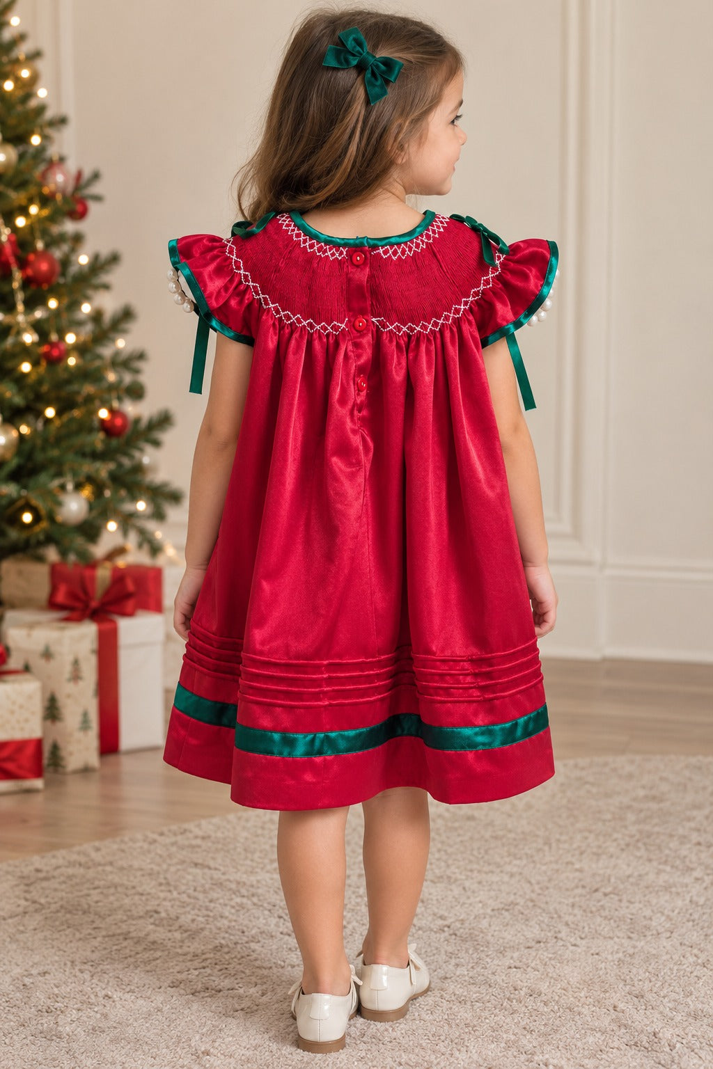 Back view of a girl wearing the red Nutcracker dress, showing smocking, green sleeve bows, and green hem trim.